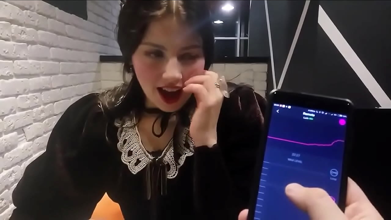 Girl is teased by boyfriend with ohmibod in restaurant