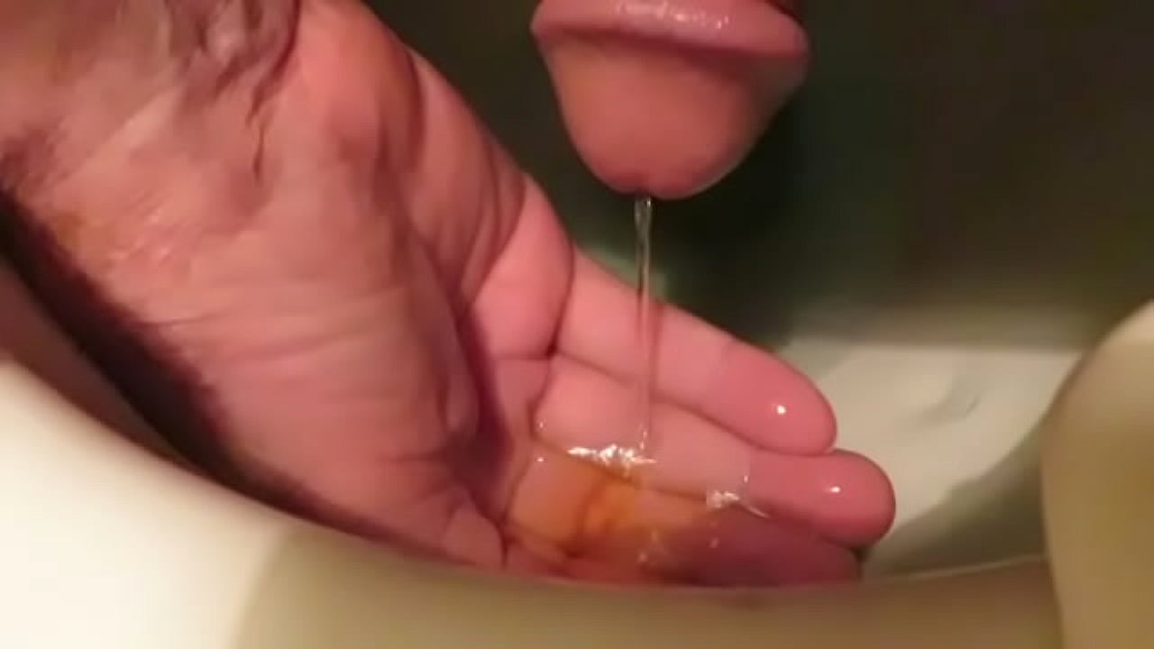 enjoying my warm piss and jacking my cock with my piss