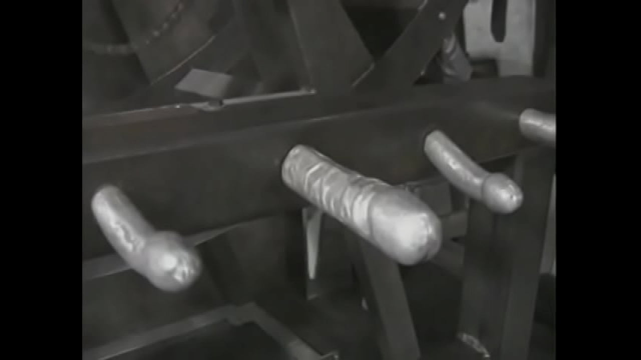 A mature blonde in a leather suit ties a young captive to a pole and hits her with a whip