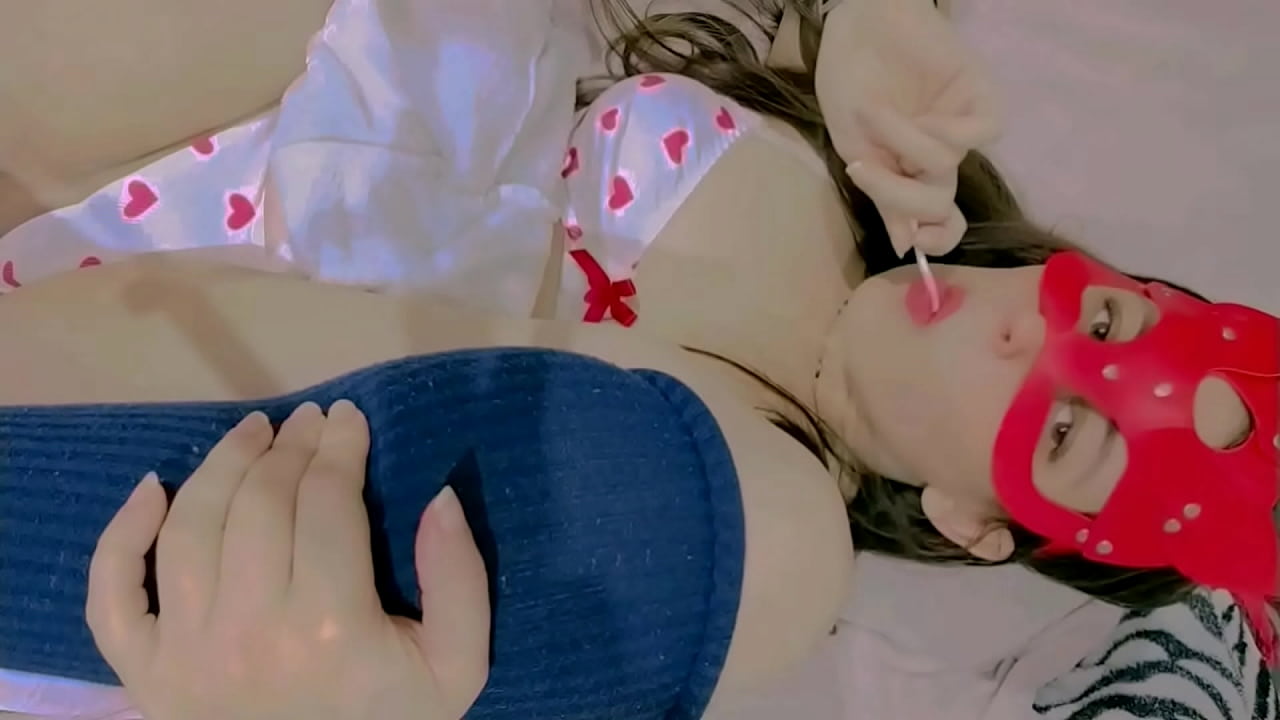 sucking lollipop lay down on the bed and masturbation