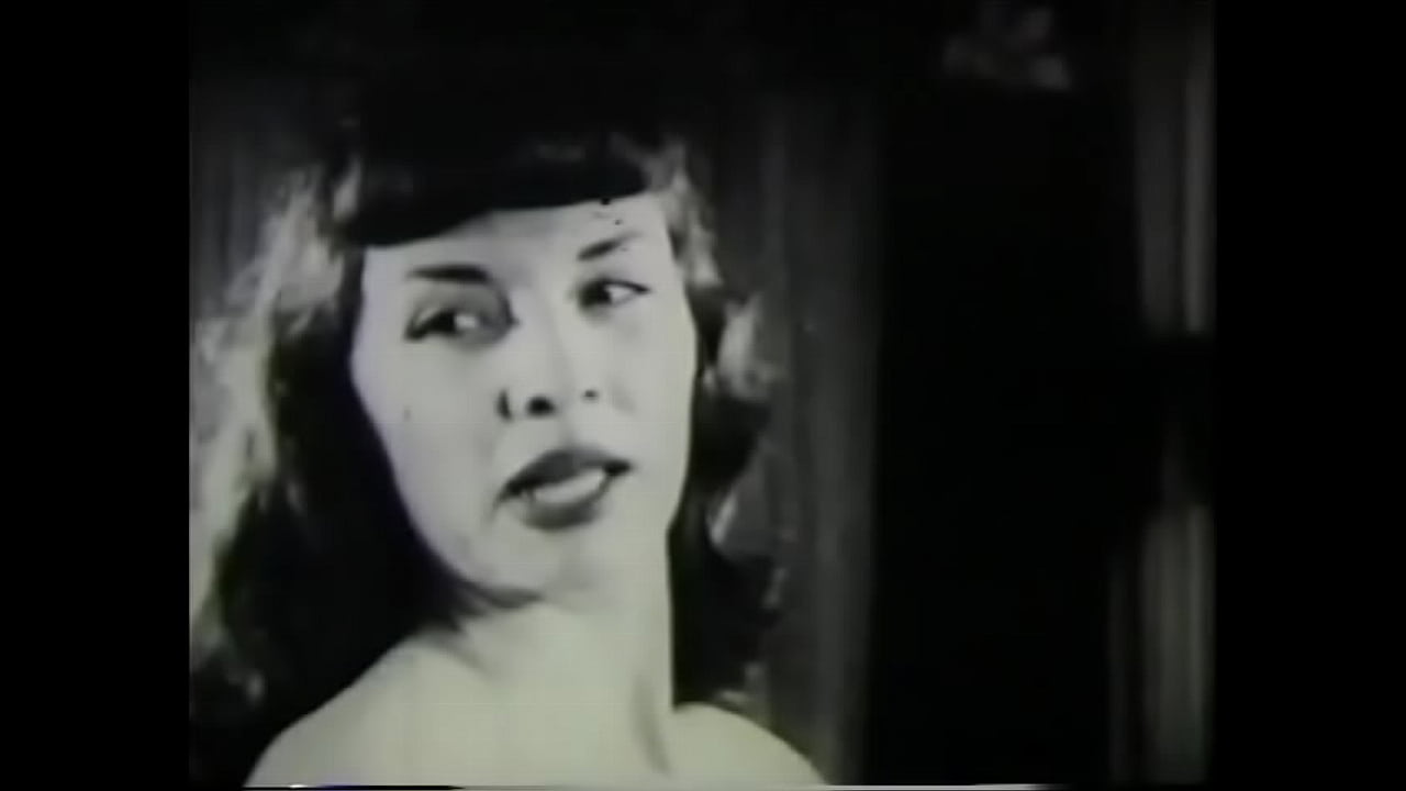 Hottie with bangs stripping on camera in vintage film 50s