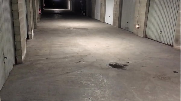 Young man piss then masturbates his long sex and have a cumshot over a wall in car-park  