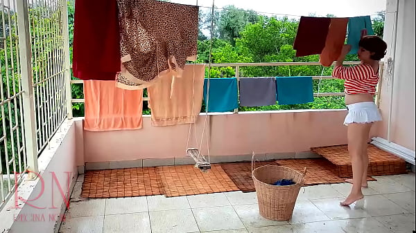 Naked laundry. The maid is drying clothes in the laundry.