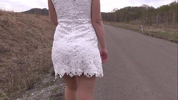 A naked girl with a juicy booty and hairy cunt walks on a public road. Peeping and exhibitionism.