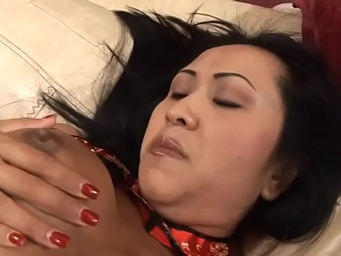 Asian MILF in bikini rubs her pussy on the sofa