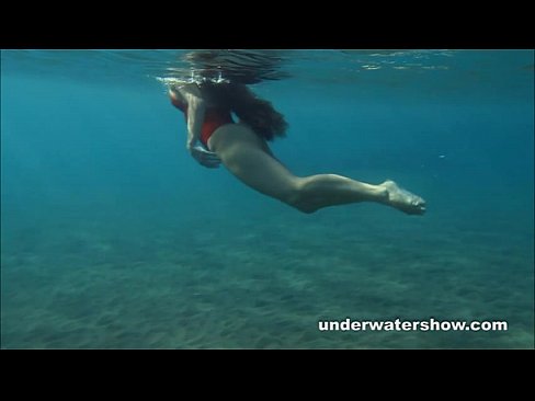Julia is swimming underwater nude in the sea