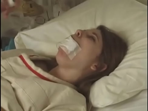 Pretty brunette in Straitjacket taped mouth tied to bed hospital