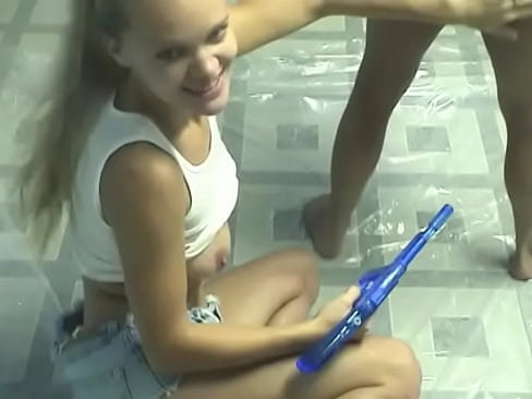 Horny lesbian girls strip and satisfy themselves with a water gun