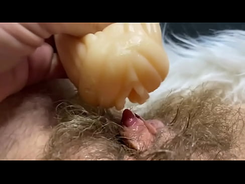 Hairy pussy cums in closeup by big clit inside flashlight