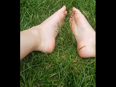 Hot girl Barefoot walking on the grass