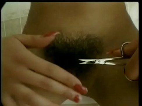 Sexy young babe trims her pubic hair and enjoys teasing her skin with hot shower