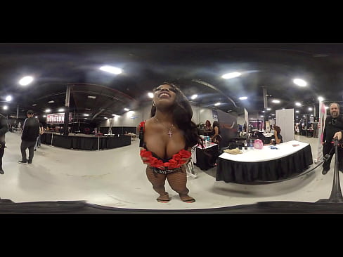 Dominatrix shows off body at porn convention in virtual reality