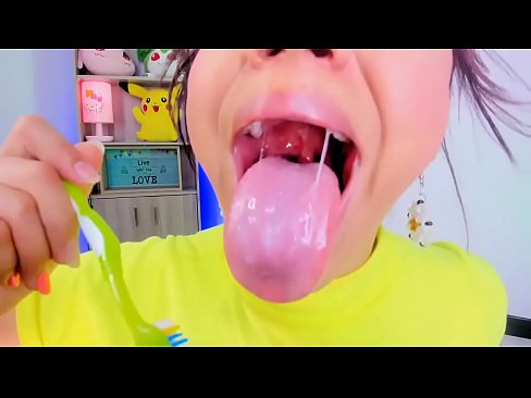 Lila Jordan uses a toothbrush to brush her teeth and tongue