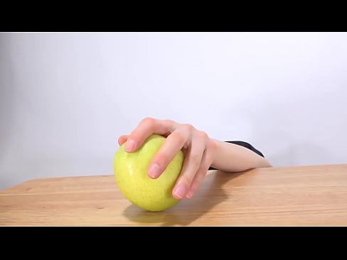 Woman's hand grabs an apple