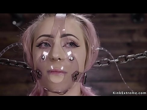 Alt blonde chained in standing position in extreme device bondage with plastic mask on her face then bent over gets ass whipped by master The Pope