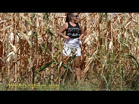 Chubby girl really needs to empty her bladder so she went into a corn field and pee with a big jet. PA211