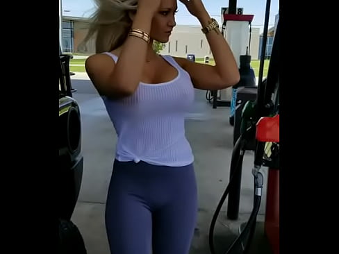 Beautiful babe pumping gas