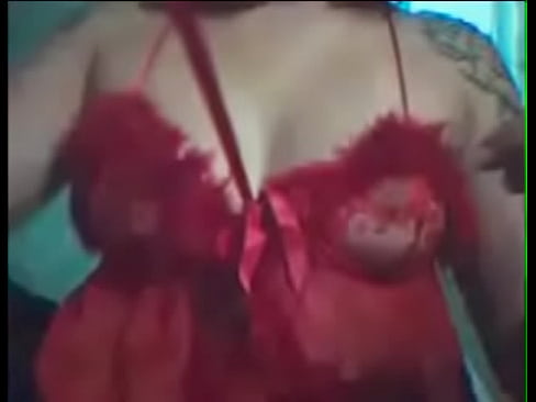 Slutty teacher Daniela in a cam show in a red dress doing a strip