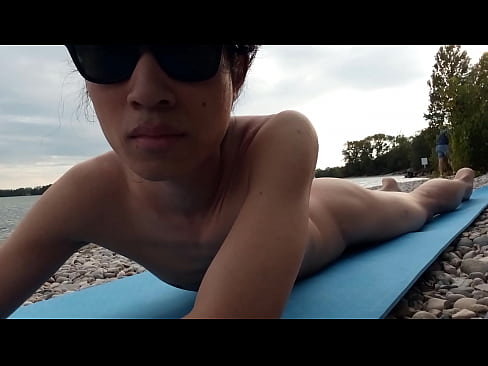 This cute Asian twink is nude for the first time on this French nudist beach, guys stare at him, go near him, think to put their dick in his little ass hole