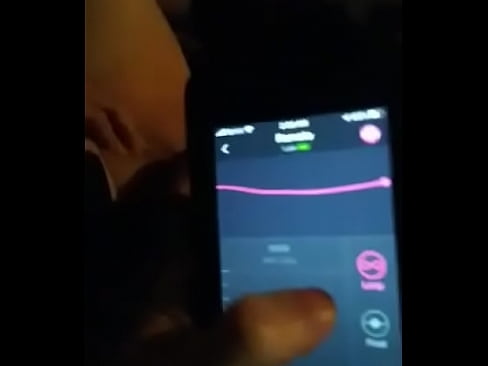 Young women Pleasing and vibrating her pussy while he uses the phone App at home