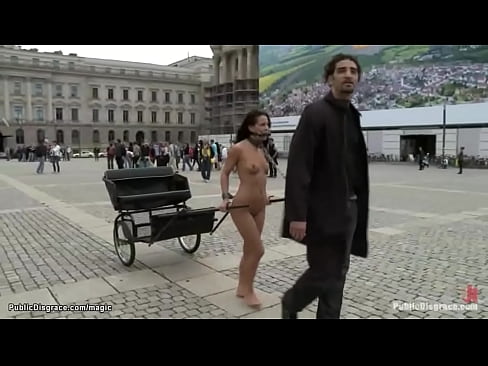 Naked petite Romanian brunette babe Amabella pulling chariot in public square then gets anal fucked by big cock Zenza Raggi in the park