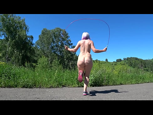 Completely naked girl with a hairy pussy on the road jumping rope, her juicy buttocks deliciously shaking.