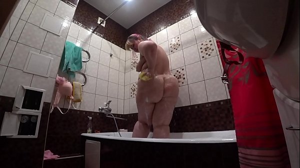 Candid camera behind the scenes, bbw with a shaking butt in a cream after an erotic shooting is washed in the shower.