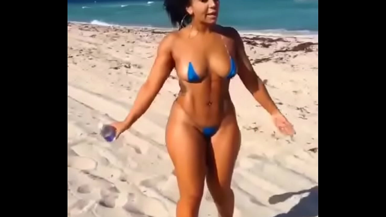 Sexy Latina in mini bikini on the beach