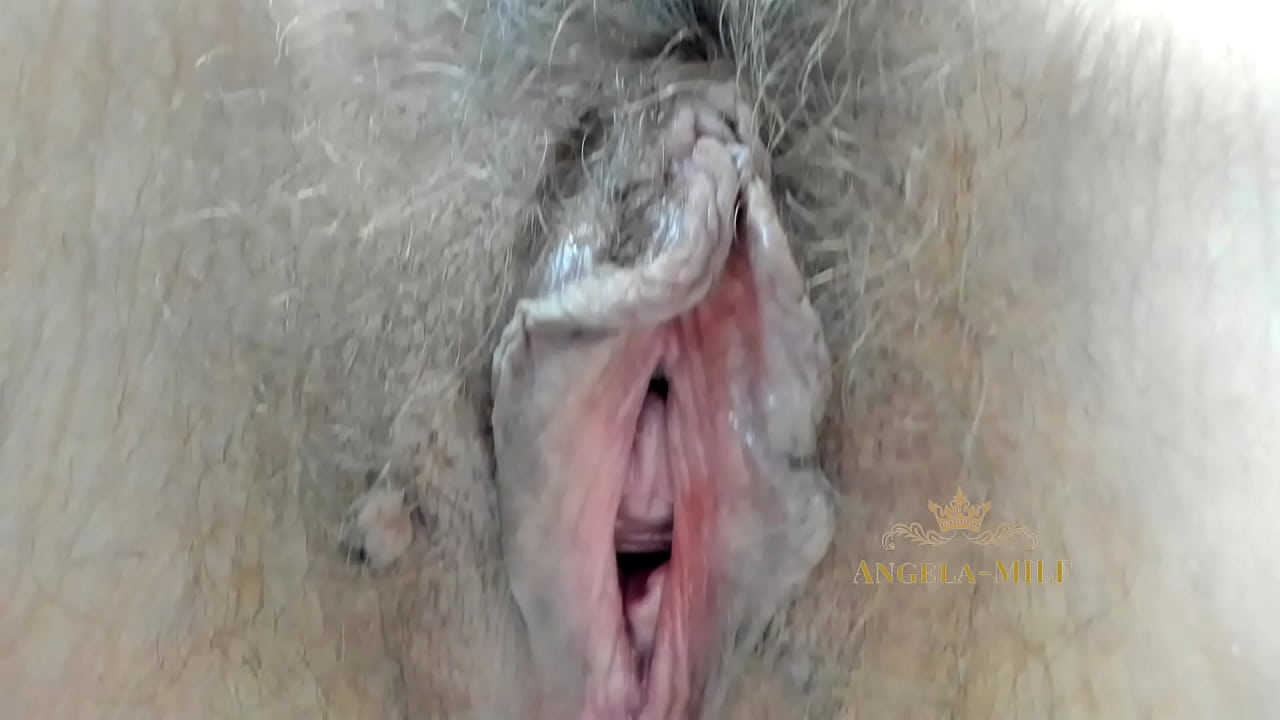 MILF fingering her furry pussy close-up