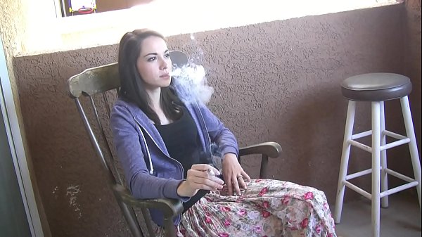 Teen pornstar and smoking girl Emily Grey enjoys a cigarette break during a porn shooting filmed with spy cam