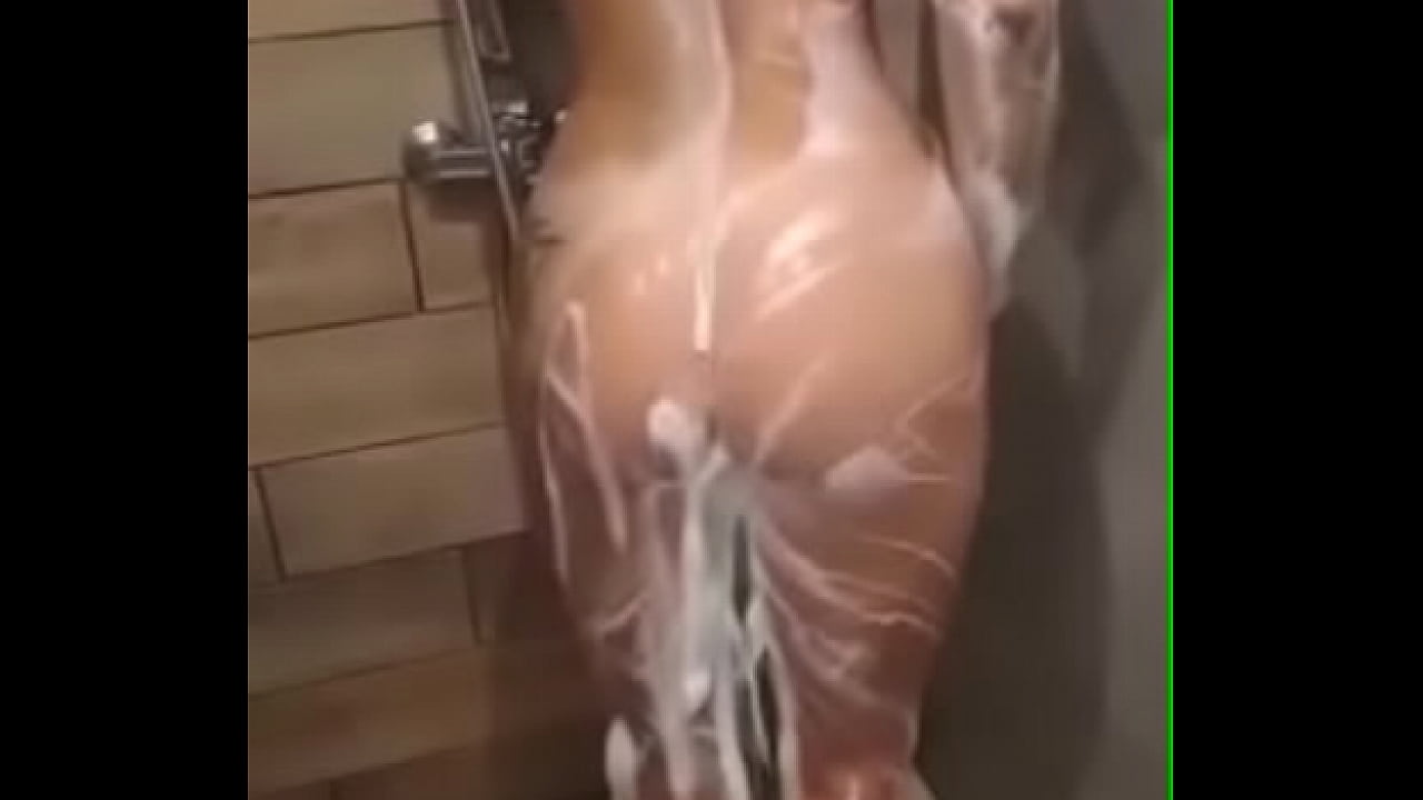 A beautiful girl washes in the shower and touches her beautiful body